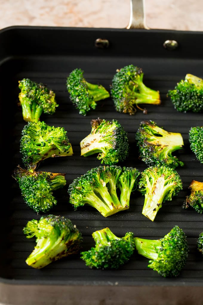 Broccoli florets on a grill pan.