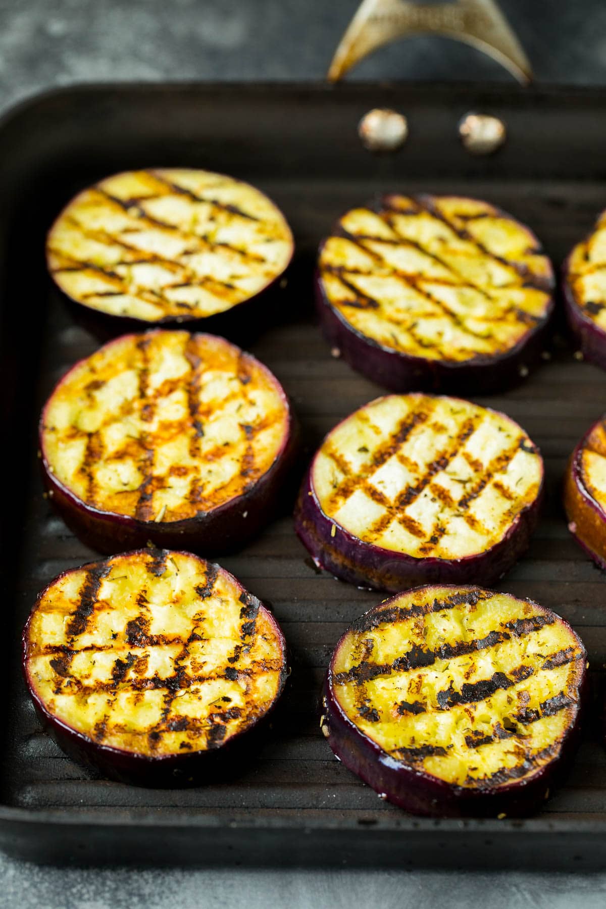 Eggplant slices cooked on a grill pan.
