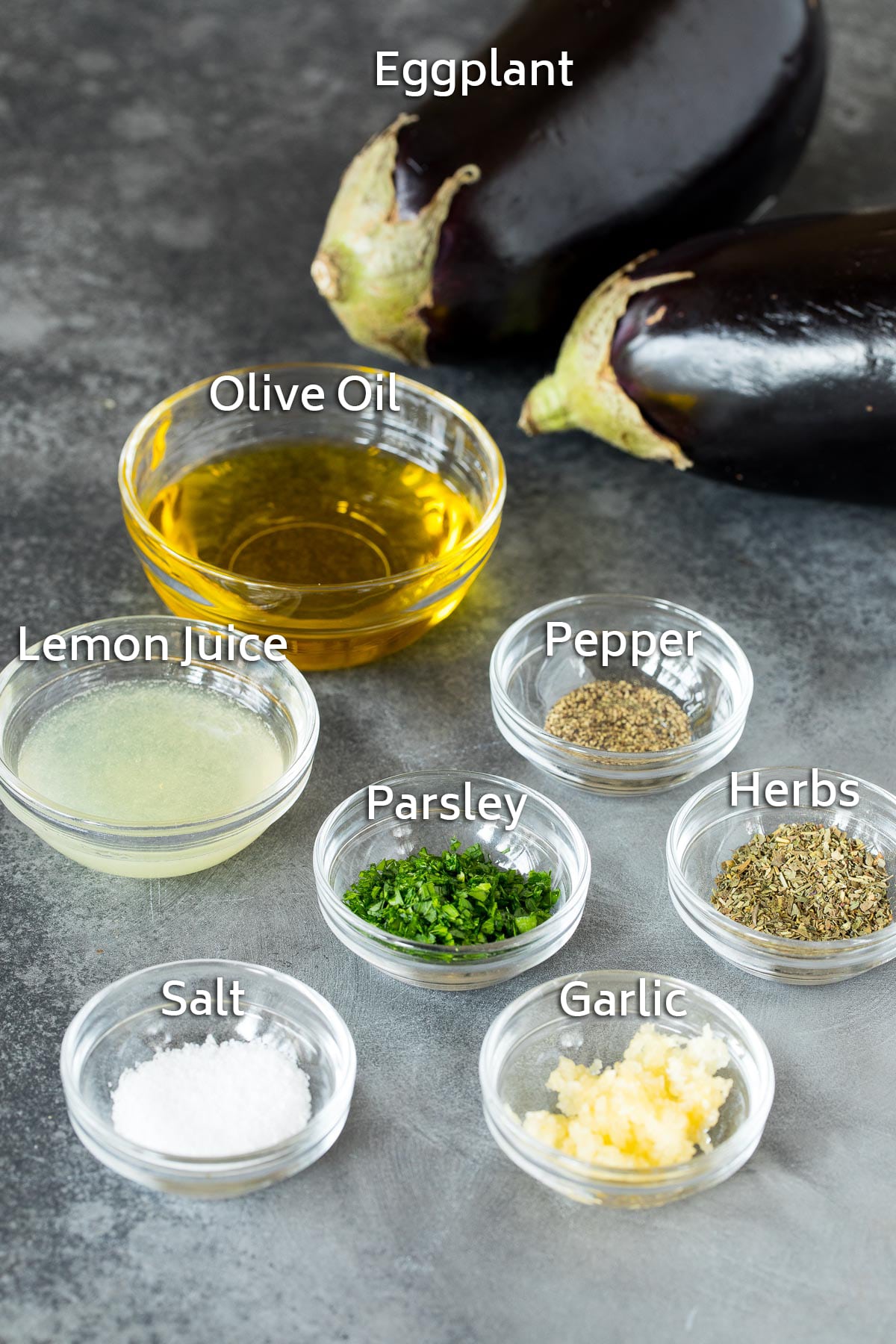 Bowls of ingredients including olive oil, lemon juice, herbs and spices.