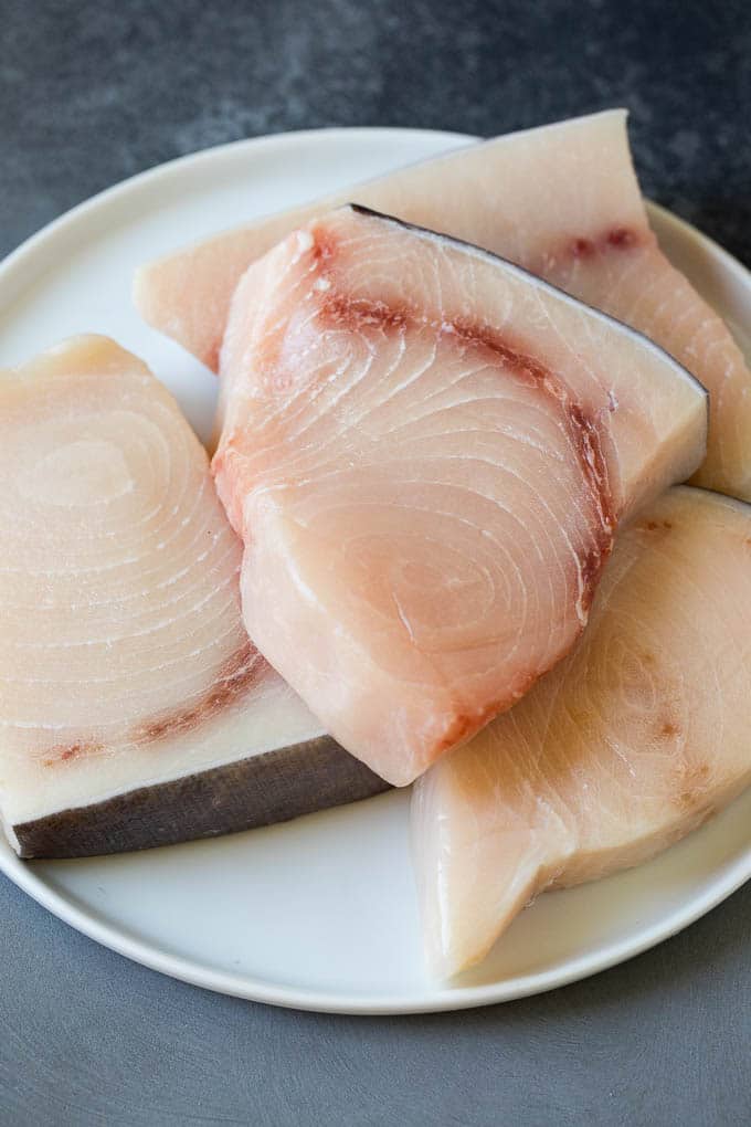 Raw fish fillets on a plate.