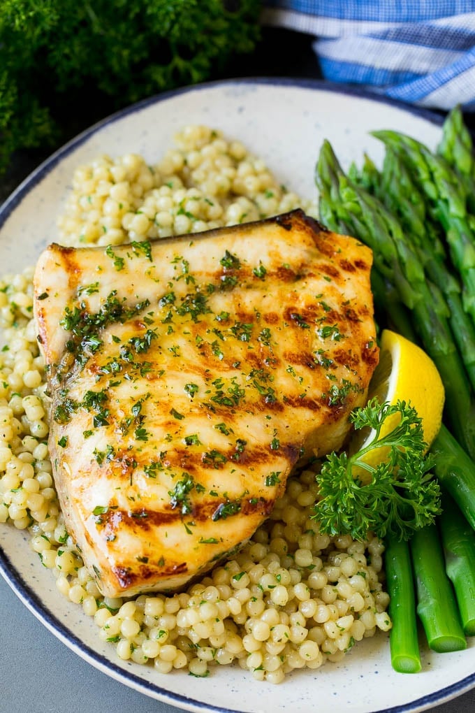 Grilled swordfish served with couscous and asparagus.