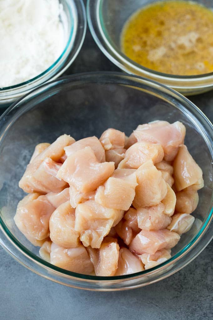 Bowls of diced chicken, eggs and flour.