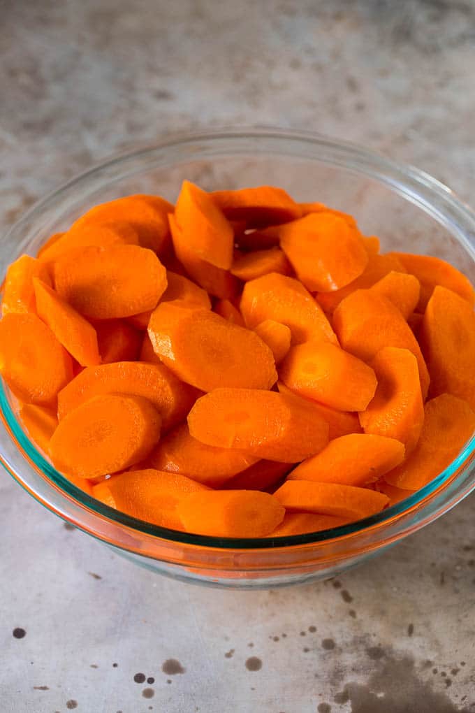 Sliced carrots in a glass bowl.