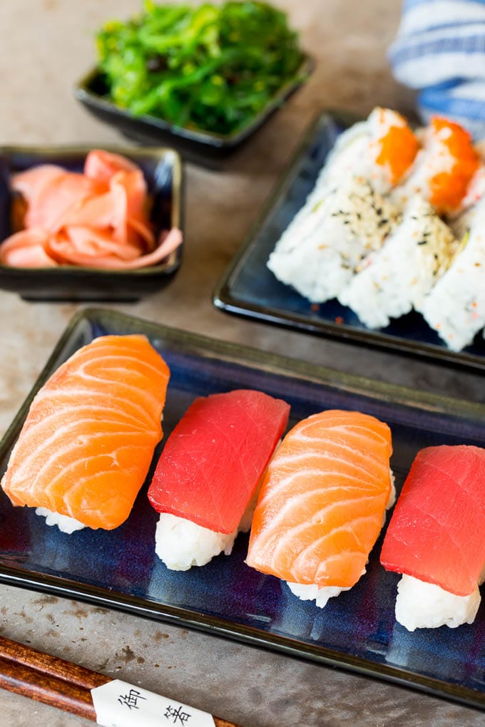 Sushi rice with fish on top and in California rolls.