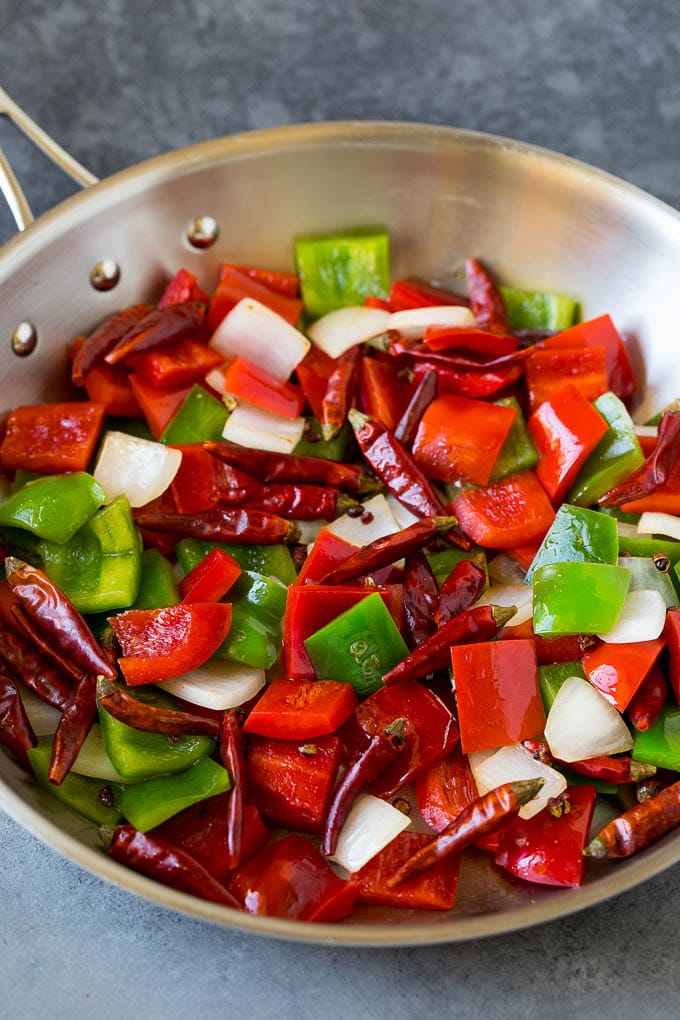 Bell peppers, chiles and onions in a pan.