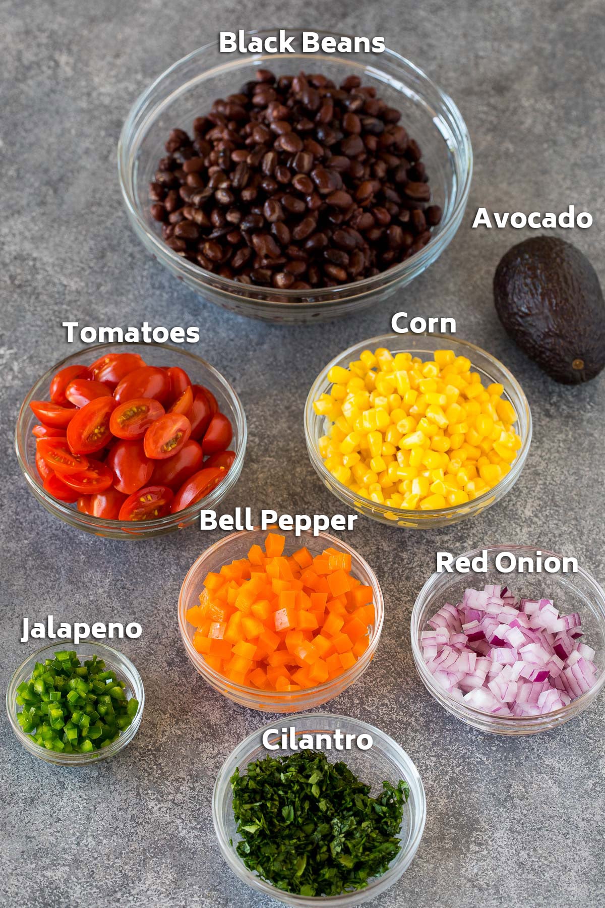 Bowls of black beans, vegetables and cilantro.