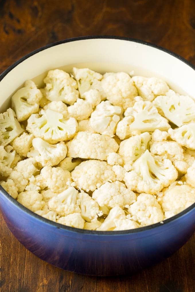 Cauliflower florets in a pot of water.