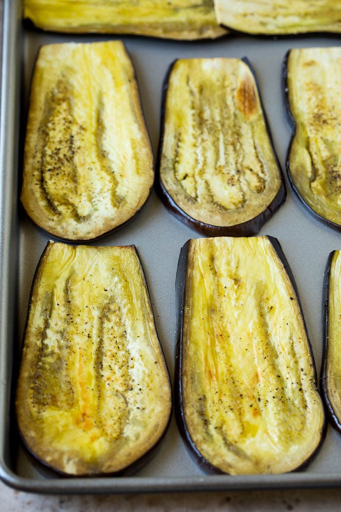 Roasted eggplant slices on a sheet pan.