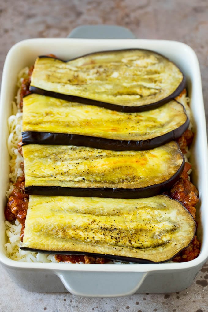 Layers of eggplant, sauce and cheese in a baking dish.