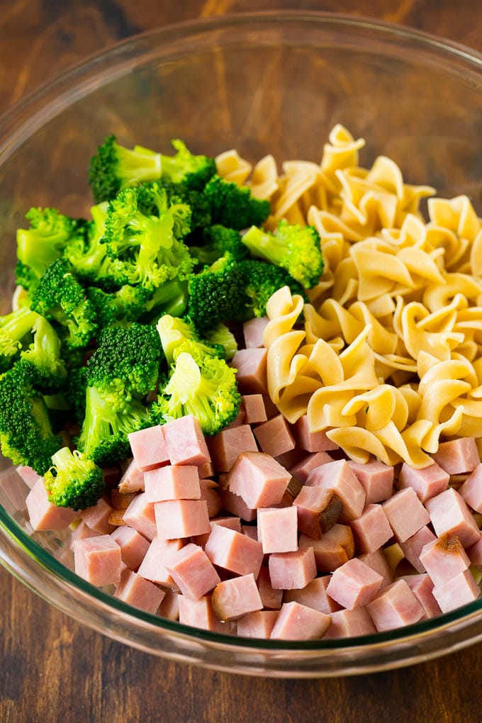 Diced ham, broccoli and egg noodles in a bowl.