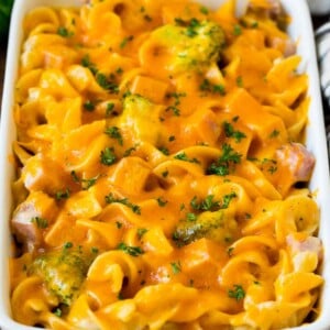 Ham casserole with egg noodles and broccoli, topped with melted cheese.