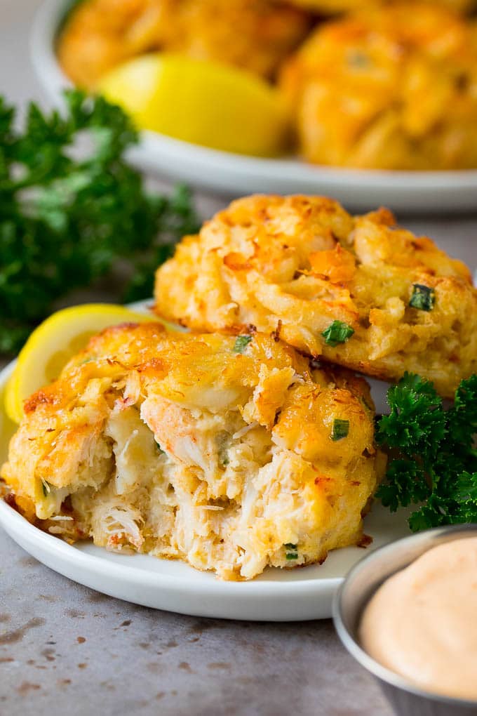 A serving of Maryland crab cakes with a side of remoulade sauce.