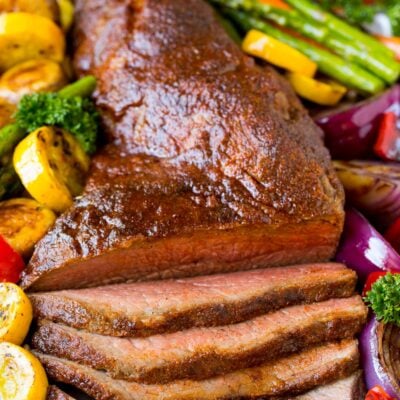 A platter of smoked tri tip served with vegetables.