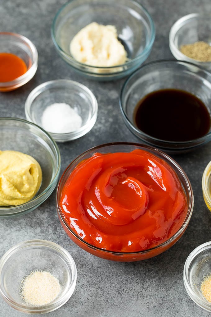 Bowls of ketchup, mustard, horseradish and spices.