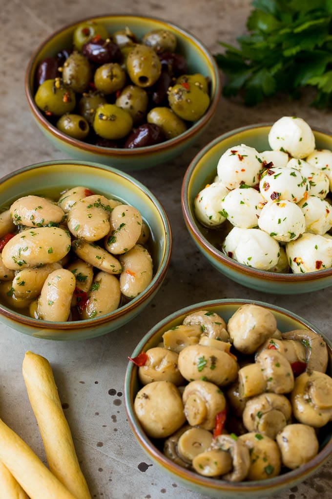 Bowls of mozzarella balls, marinated beans, mushrooms and olives.