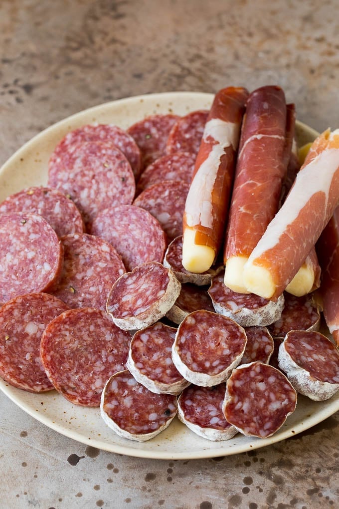 Assorted cured meats arranged on a plate.
