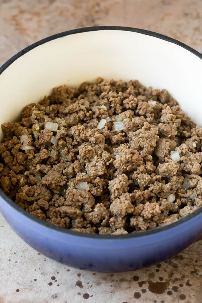 Cooked ground beef and onions in a pot.