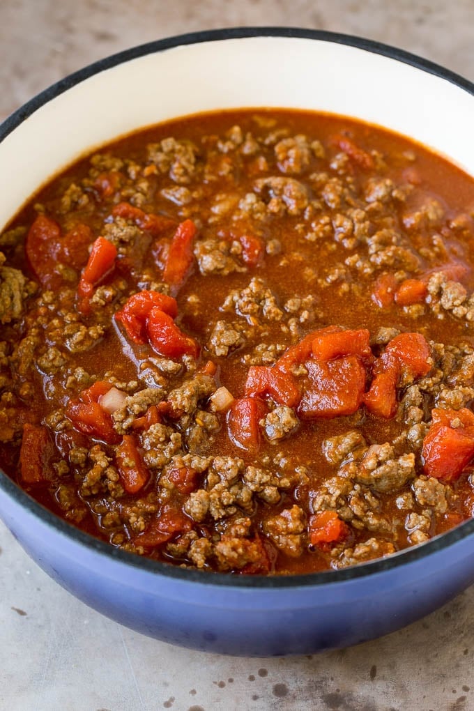 Beef, tomatoes, seasonings and broth in a pot.