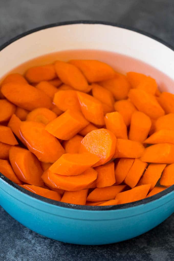 Sliced carrots in a pot of water.