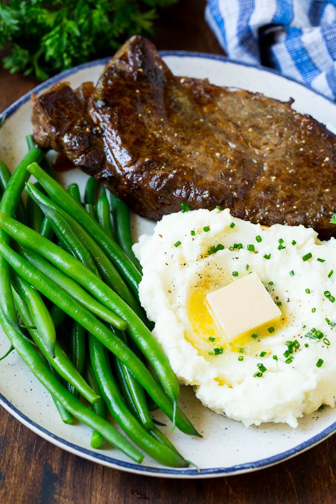 Cream cheese mashed potatoes served with steak and green beans.