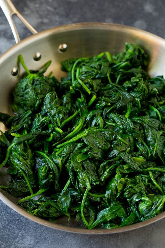 Cooked greens in a pan.