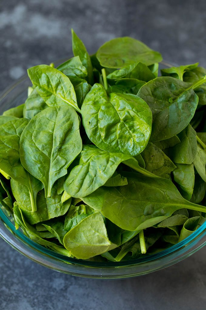 Fresh spinach leaves in a bowl.