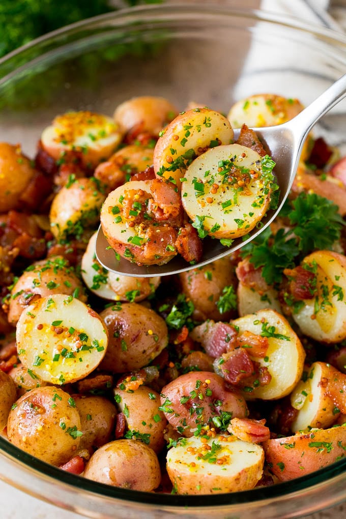 A spoon serving up a portion of German potato salad.