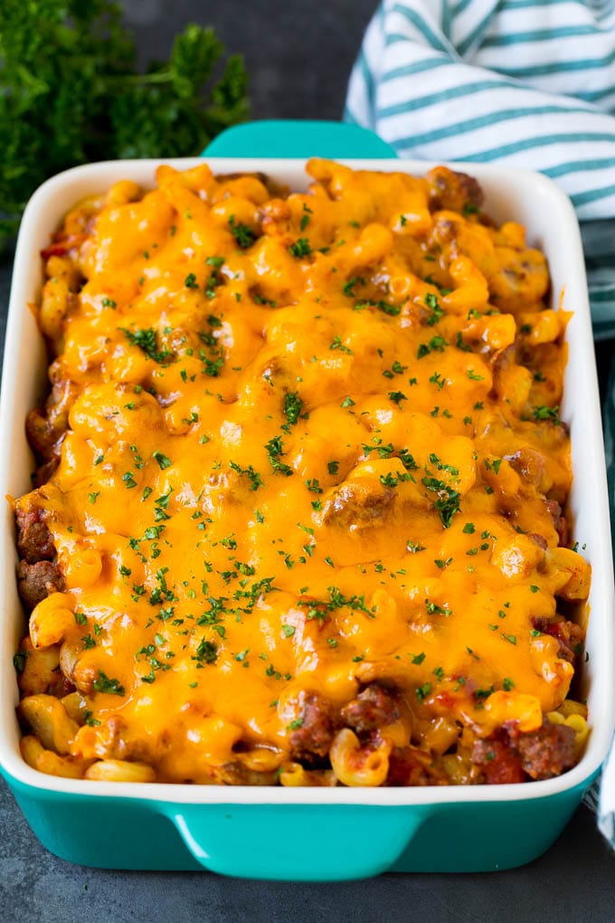 Hamburger casserole with pasta and ground beef, all topped with melted cheese.