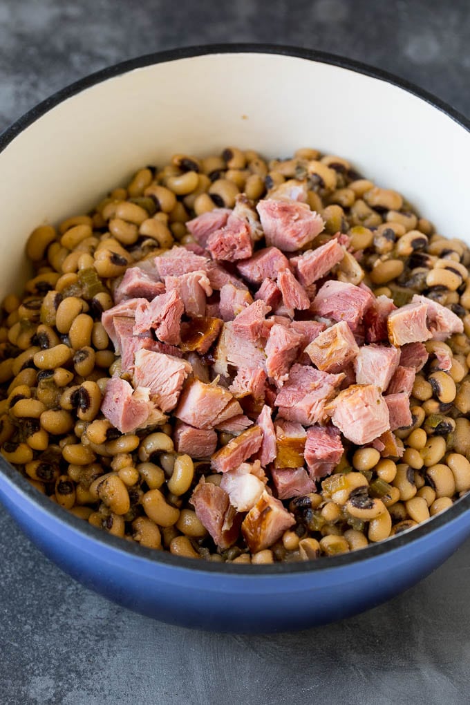 Diced ham in a pot of cooked black eyed peas.