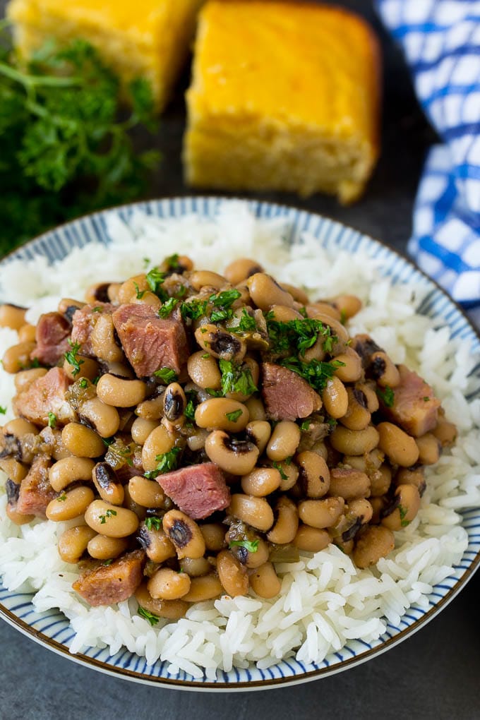 Hoppin' John served over steamed rice and garnished with parsley.