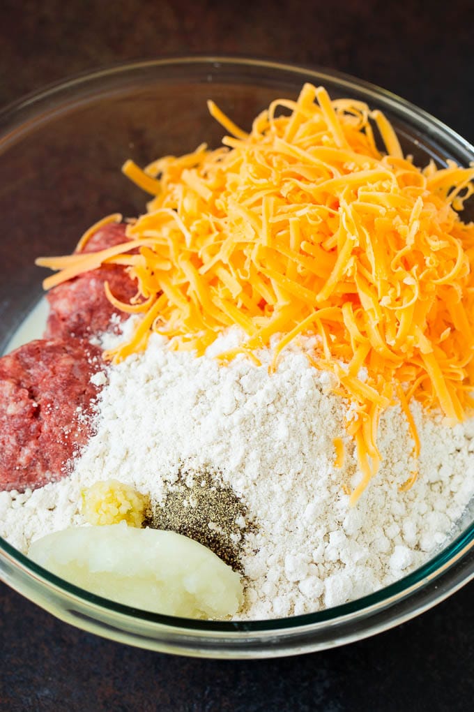 Sausage, cheese, bisquick and seasonings in a bowl.