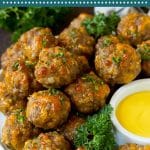 This sausage balls recipe is a blend of pork sausage, cheddar cheese, bisquick and seasonings, all formed into balls and baked to golden brown perfection.