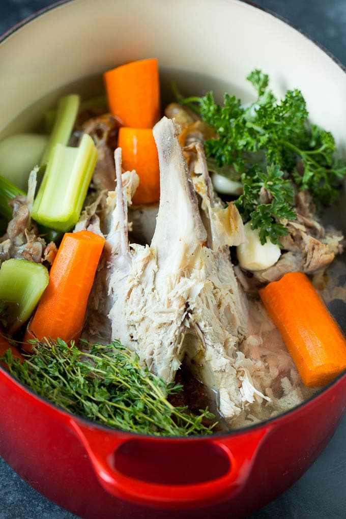 A bones, meat and vegetables in a pot of water to make broth.