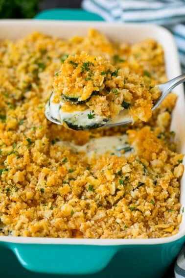 A spoon serving up a portion of zucchini casserole.