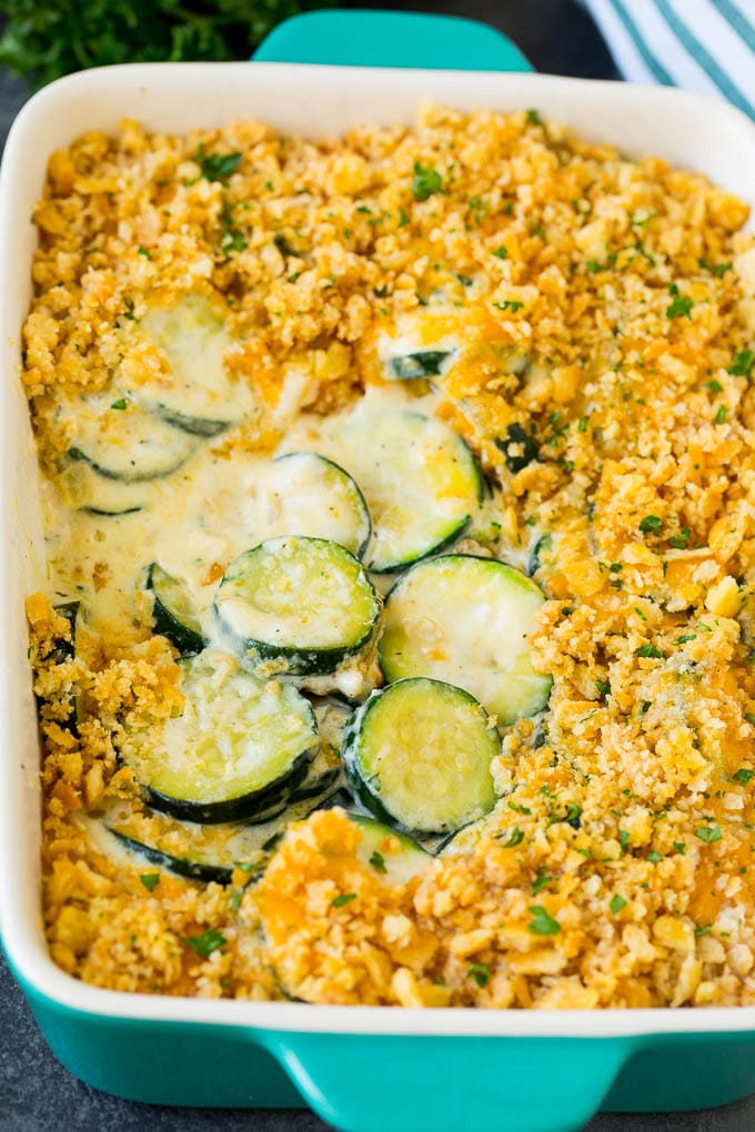 Zucchini casserole with sliced squash in a creamy sauce, topped with melted cheese and cracker crumbs.