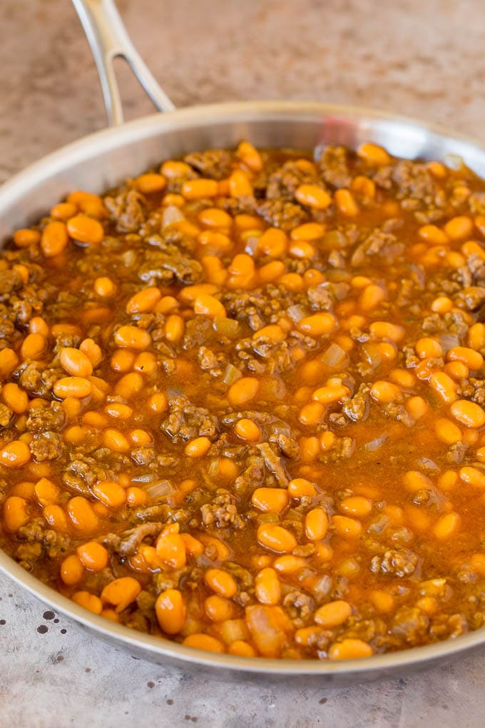 Beans, ground beef and seasonings in a pan.