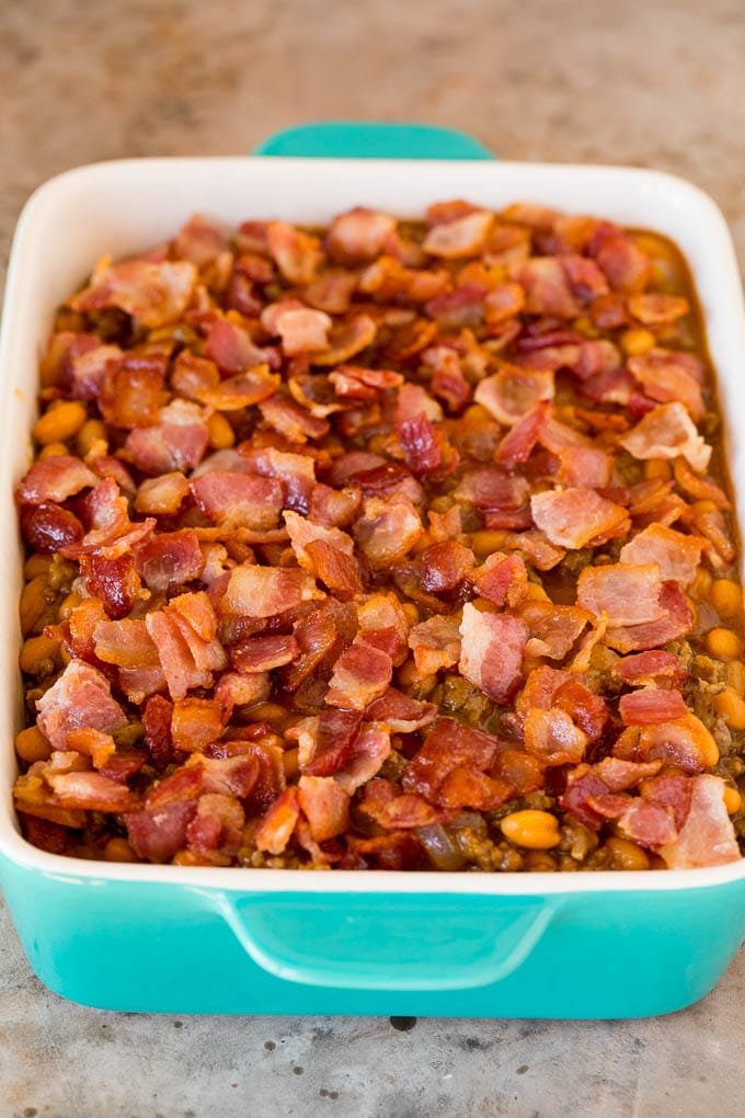 A baking dish of beans topped with diced bacon.