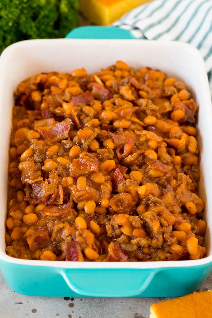 A serving dish of cowboy beans with bacon.