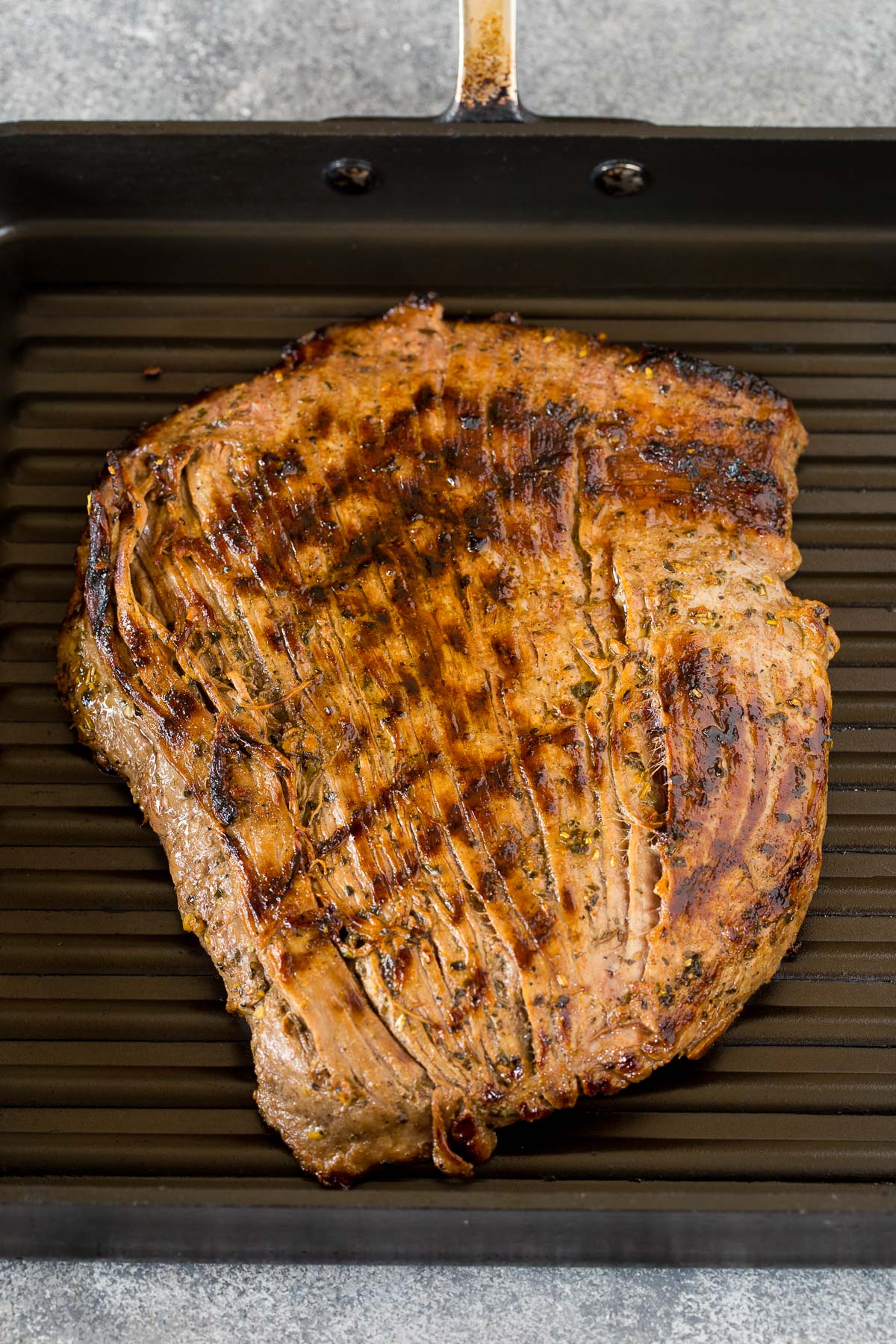 Flank steak cooked on a grill pan.