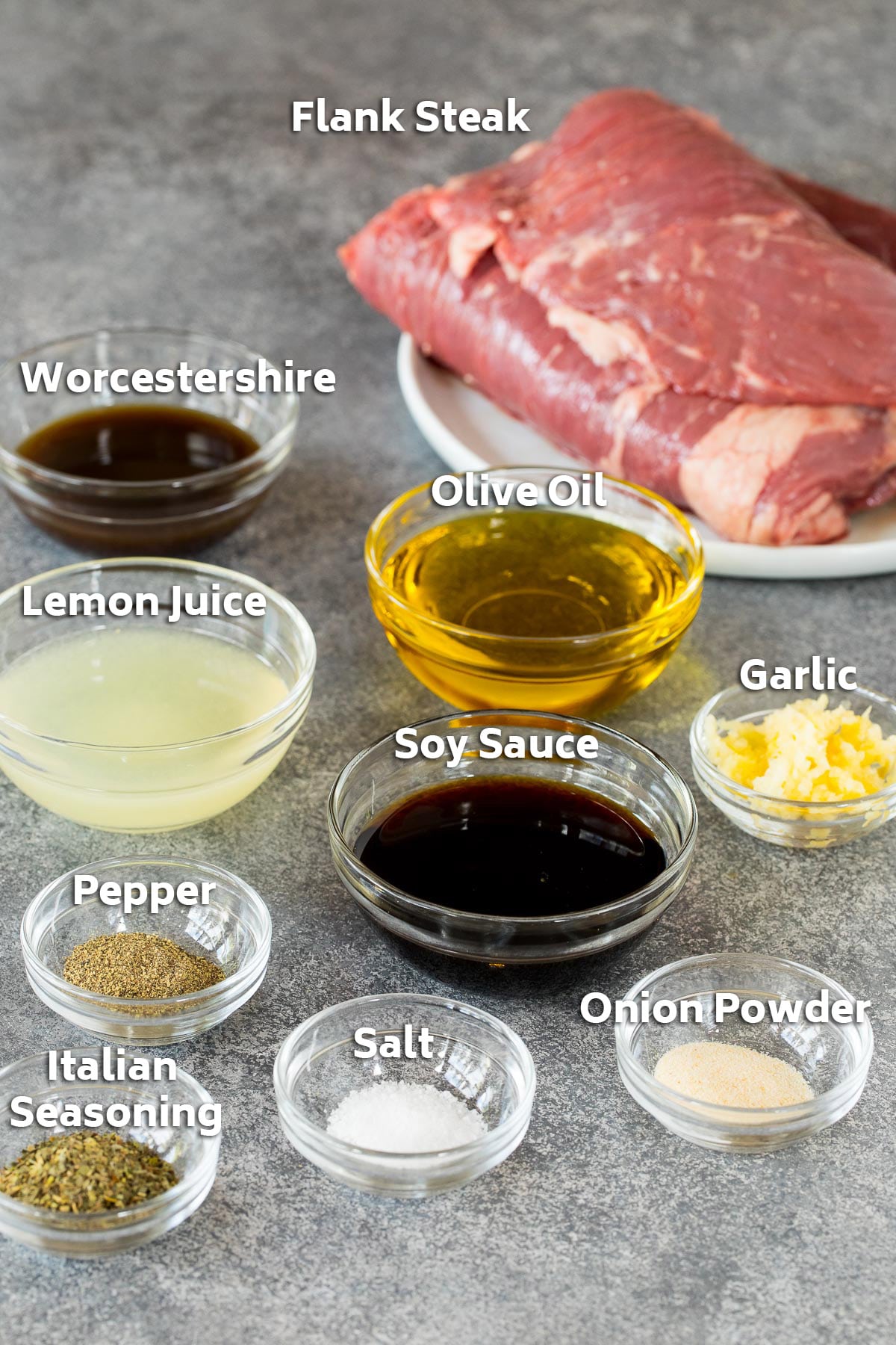 Bowls of marinade ingredients and a plate of flank steak.