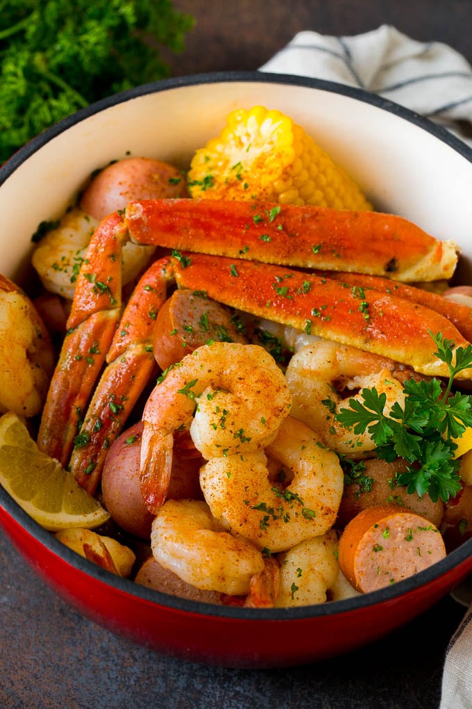 A pot of Low Country Boil with shrimp, crab and vegetables.