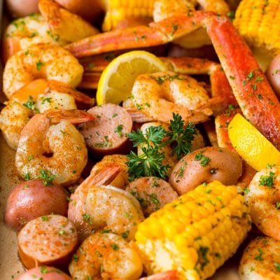 A Low Country Boil with shrimp, crab, sausage corn and potatoes on a sheet pan.