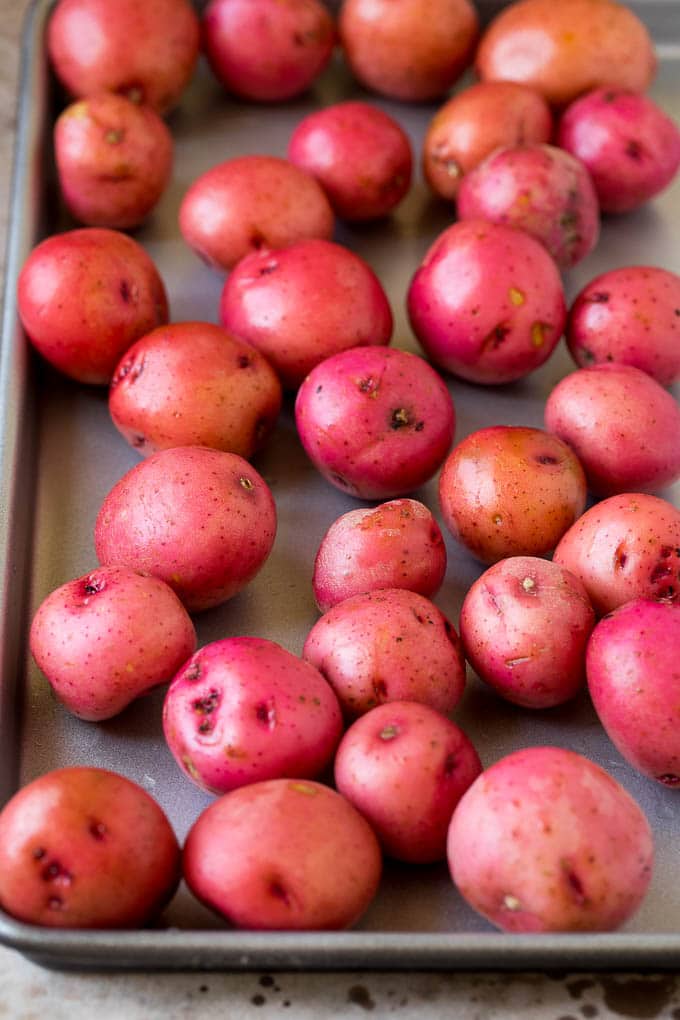 Whole potatoes on a sheet pan.