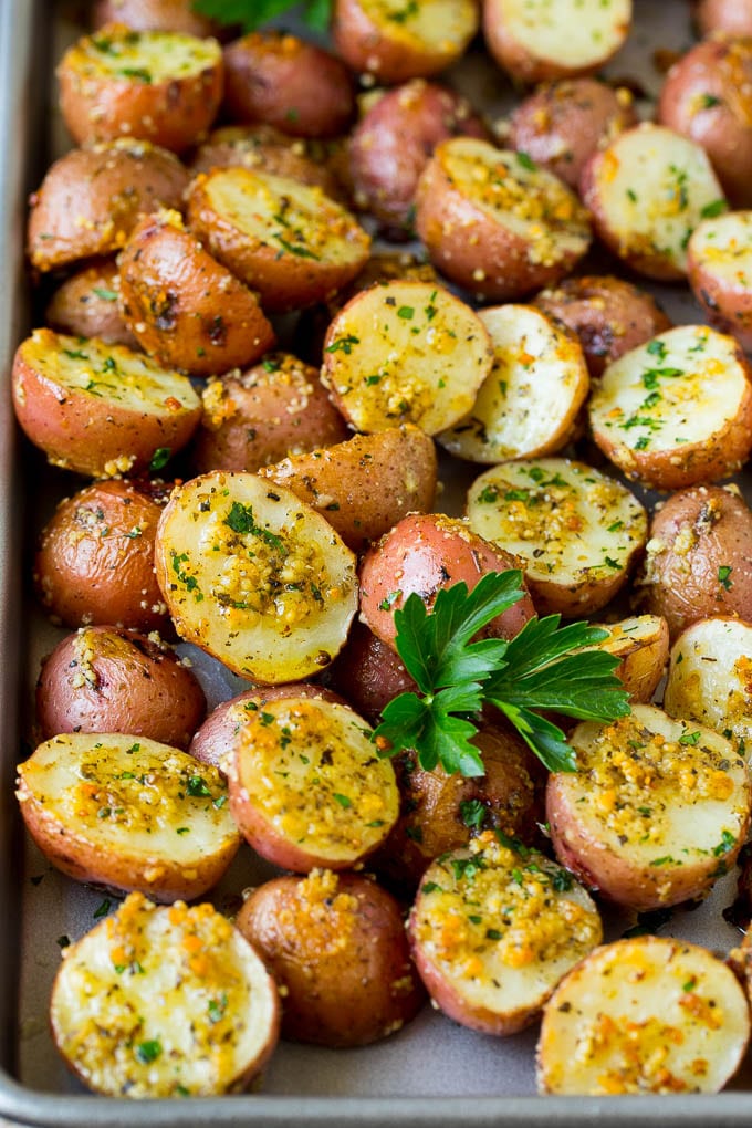 Oven roasted potatoes coated in garlic and herbs, then garnished with parsley.