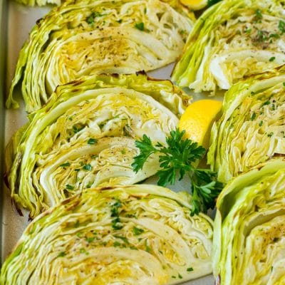 Roasted cabbage on a pan topped with fresh parsley.