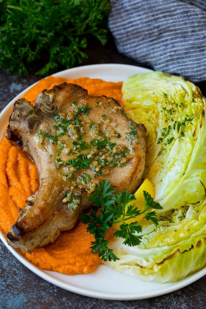 Roasted cabbage served with pork chops and sweet potatoes.