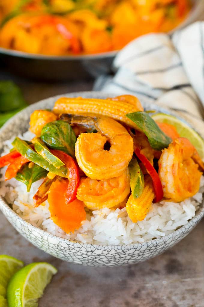 A bowl of shrimp curry served over rice.