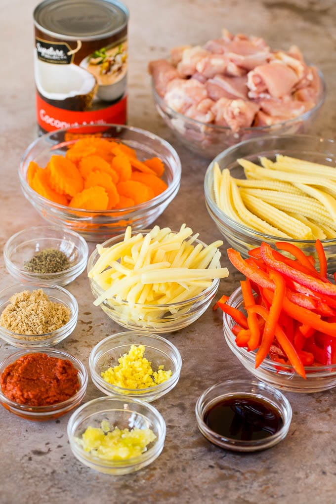 Bowls of diced chicken, vegetables and seasonings.