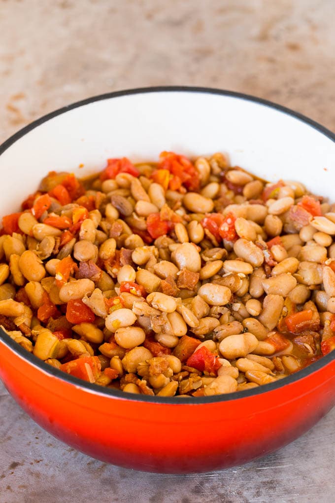 A pot of pinto beans cooked with bacon and tomatoes.