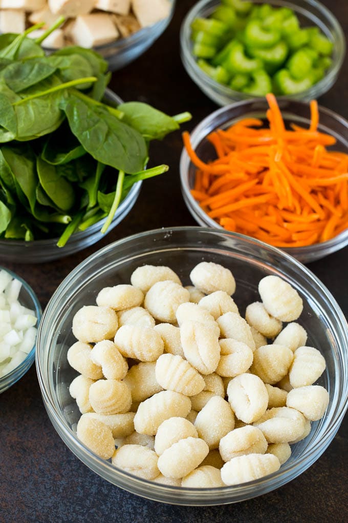 Bowls of gnocchi, chicken and vegetables.